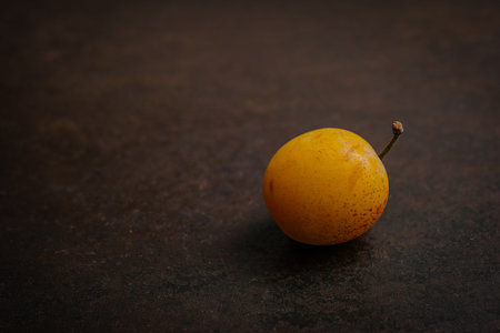 Mirabelle small yellow plum fruit on black ground
