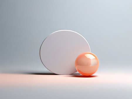 Silhouetted Grey Gradient Background Featuring White Cylinder and Orange Sphere Adjacent to Each Otherの素材