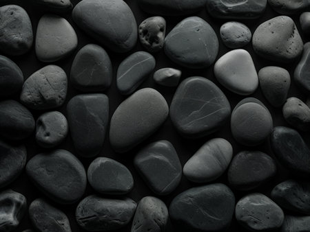 Black and white pebbles background. Top view, flat lay.の素材