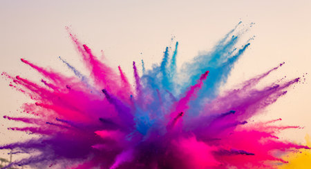 A burst of colored powder creates a vibrant display, with pink, blue, red, yellow hues radiating outward against an overcast sky.の素材