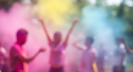 Blurry photograph of people celebrating with colored powder.の素材
