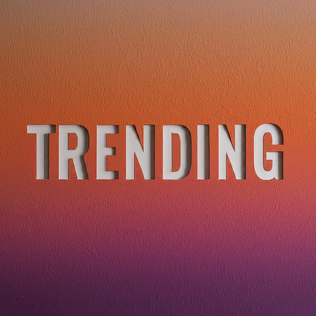 A bold graphic with the word 'TRENDING' in large white letters against a gradient background transitioning from orange to purple.の素材
