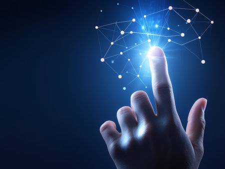 A hand pressing a glowing button that emits a network of interconnected dots and lines against a dark background.の素材