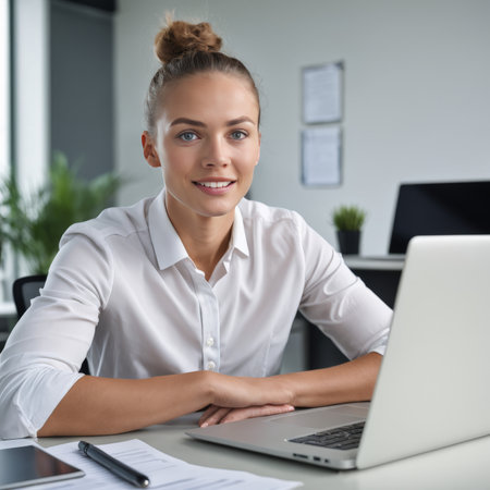 young female executive working with laptop in officeの素材