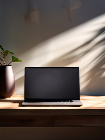 laptop with black screen on wooden table in office.の素材
