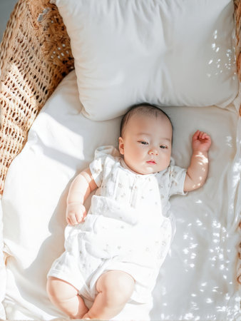 little baby lying in bed.little bed.の素材