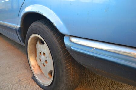 old car has a blowoutの写真素材