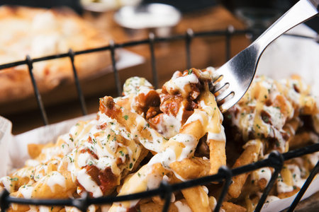 close up of rustic french fries with melted mozzarella cheese