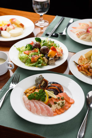 Seafood platter with salmon, vegetables and mushrooms on a tableの写真素材