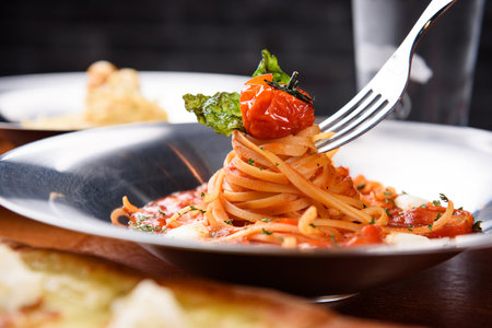 Tomato pasta topped with cherry tomatoesの写真素材