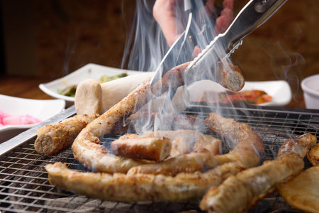 Cutting the grilled beef intestines.の写真素材