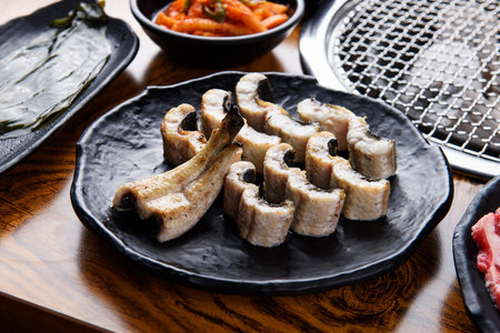 Eel on a black plate grilled over charcoalの写真素材