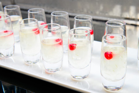 White jelly with cherries served in a round glass