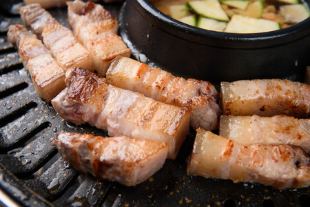 Grilled pork belly in black pan, closeup. Asian cuisineの写真素材