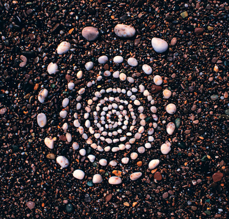 spiral of white marine pebbles on a colorful pebblesの写真素材