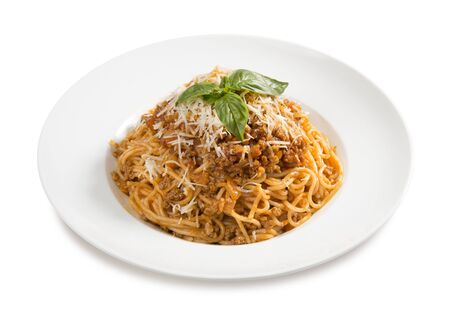 traditional pasta bolognese  with basil on a plate on a white backgroundの写真素材