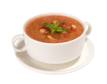 Traditional Spanish cold gazpacho soup in broth cups and saucer isolated on white backgroundの写真素材