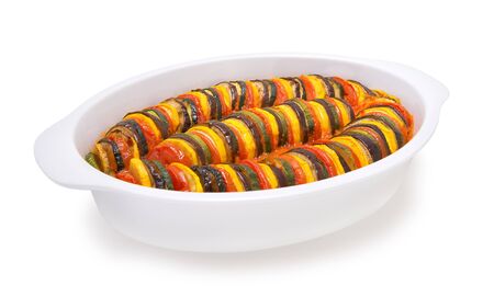 Hot vegetable ratatouille in a white casserole on a white backgroundの写真素材