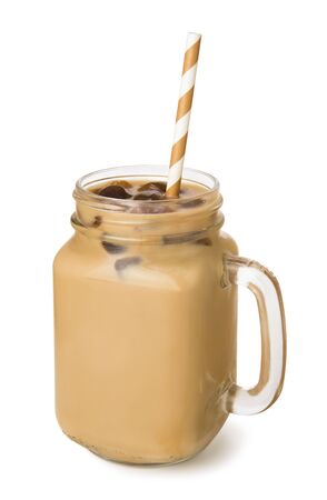 Iced coffee with milk in a glass jar isolated on white background. Summer shake.の写真素材