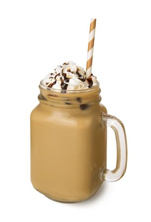 A glass jar of Iced coffee with whipped cream and chocolate sauce isolated on white backgroundの写真素材