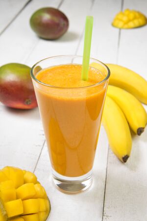 Smoothie mango with bananas with Ingredients on a old white table. Selected focus.の写真素材