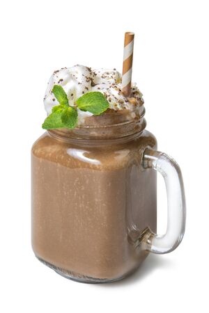 Vanilla chocolate milkshake with whipped cream and mint in glass jar isolated on white backgroundの写真素材