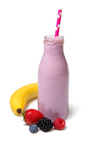 Fresh berry mix smoothie from strawberries, blackberries, blueberries and raspberries in a glass bottle on a white background isolatedの写真素材