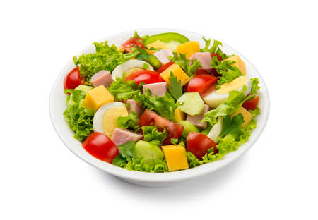 Chef salad with tomato, cucumber, lettuce, ham, bell pepper, cheese and eggs in a white bowl isolated on white background.の写真素材