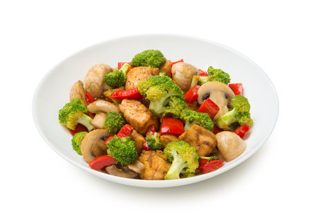 Keto low carb chicken stir fry with bell peppers, mushrooms, ginger and broccoli in a salad bowl isolated on white background.の写真素材
