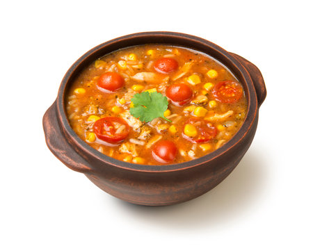 Easy Mexican chicken and rice soup in a terracotta soup bowl isolated on white background.の写真素材