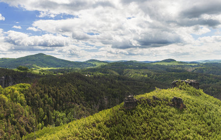 Beautiful view of the landscape of Bohemian Switzerland. The photo shows rocks between trees and clouds in an otherwise blue sky. The photo is taken from the top of Maria Rock.の写真素材