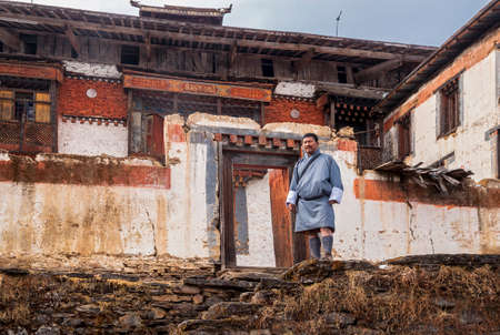 Thimphu/ Bhutan - February 28, 2016: Bhutan mÐ°n in traditional Bhutanese clothes on the background of buildings of Padjoding monastery, Himalayaのeditorial素材