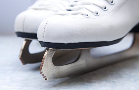 Pair of female figure white skates, white boots. Close up.