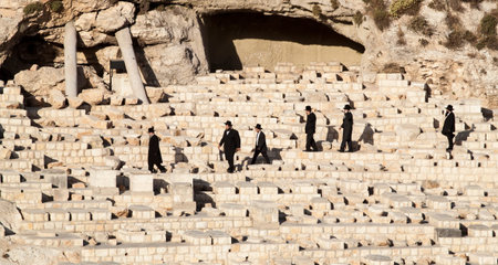 JERUSALEM/ISRAEL - 11 June 2013: a group of orthodox jews go to Funeral ceremony near graves of the...