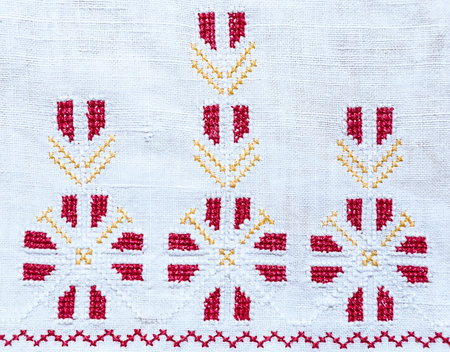 Fragment of embroidery handmade cross-stitch pattern on vintage tablecloth or napkin, ukrainian...