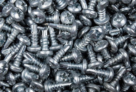 Chrome self-tapping screws. Background of the self-tapping screws.