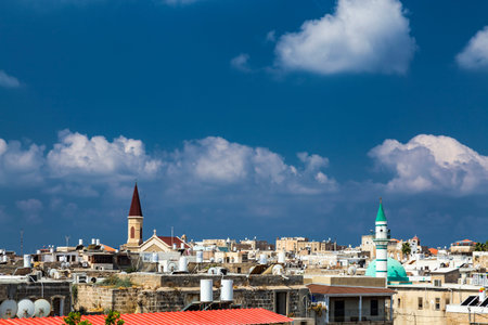 Acre, Israel - 3 of August 2019: The Acre skyline with its landmarks - mosques' domes and minaret...
