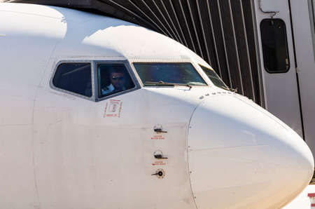 Kharkov / Ukraine - August 19, 2018: Nose of Airbus A319 closeup of FANair in Kharkov Airport, pilot in the cockpitのeditorial素材
