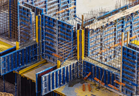 Installed formworks and iron rebars or reinforcing bar for reinforced concrete partitions at the construction site of a large residential building.の写真素材