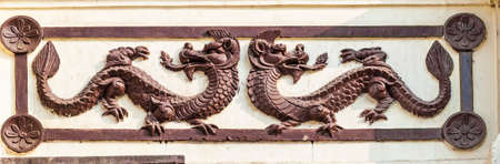 Nepal / Kathmandu - February 2016: Nepalese wooden carving with dragons in hinduism Pashupatinath complex, cremation of the dead on the banks of the sacred Bagmati river. Kathmandu, Nepalのeditorial素材