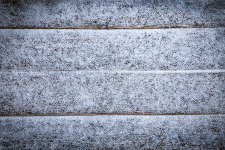 Old wooden board covered with white fresh snow. Flat lay. Christmas winter background.の写真素材