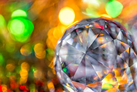 Closeup of crystal glass faceted ball on background of festive lights. Abstract festive, christmas or interior background. ? hristmas decoration.の写真素材