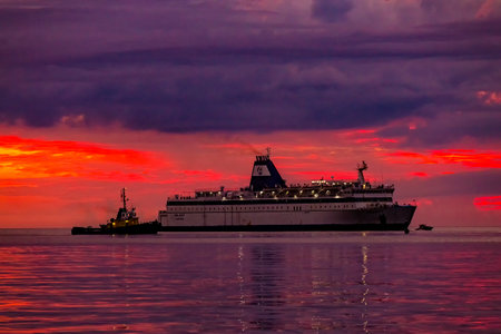 Vlore, Albania - 5 September 2022: Big passenger ferry ship Logos Hope on sunset background in Vlore city port. Wonderful sunset on the Adriatic Sea. Travel concept background.のeditorial素材
