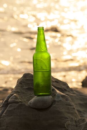 Bottles of beer on the rocksの写真素材