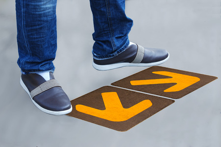 a man standing on the road. the road arrowの写真素材