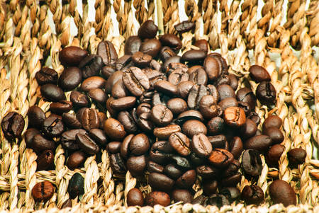 Roasted coffee beans in the wicker basket.の写真素材