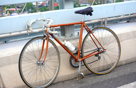 An ancient street bike parked on the street.の写真素材