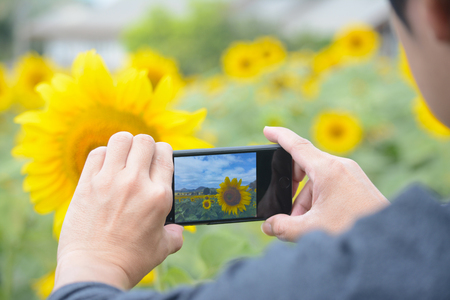 man taking photo with mobile cell phoneの写真素材