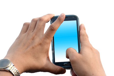 A man hands holding a smart phone with a blank screen that splits over a white background.の写真素材