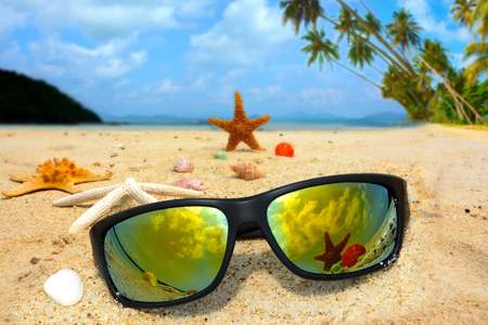 Sun glasses and starfish on the beachの写真素材